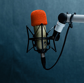 Orange microphone in a recording studio.