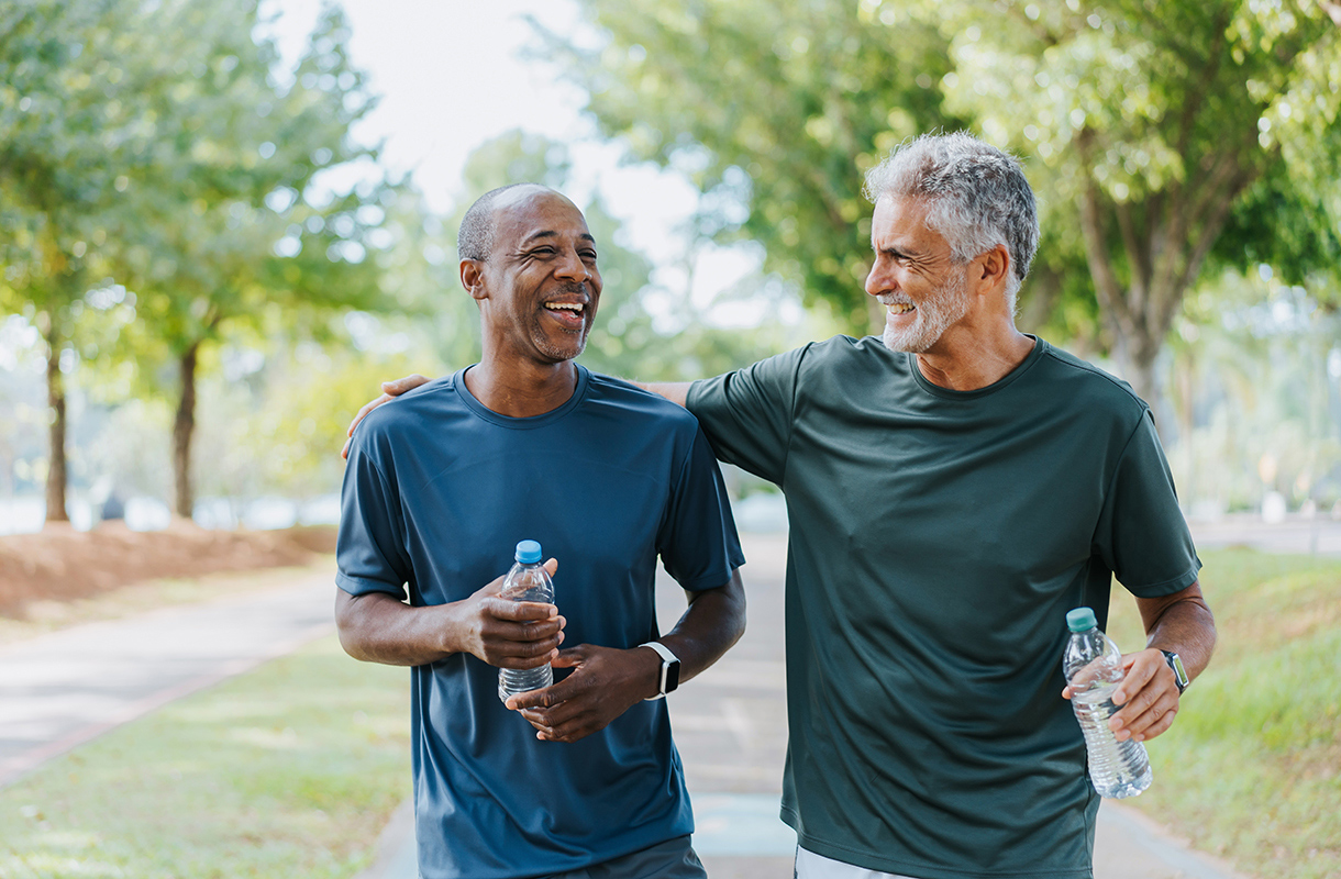 Two men walking together in a park