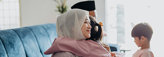A mother hugging her daughter