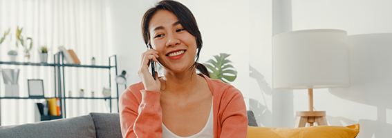 A woman talking on the phone at home