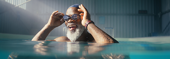 Smiling man in an indoor pool.