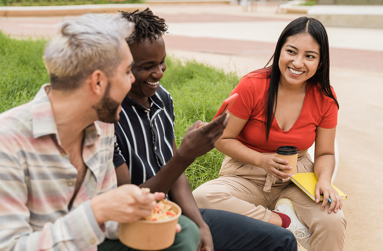 Three friends sitting outdoors