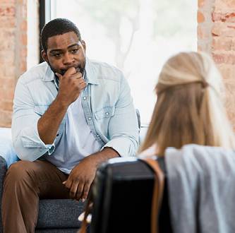 Patient listening to a mental health practitioner during a session.